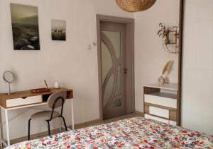 a bedroom with a bed and a desk and a mirror at The Old Corner House in Velingrad