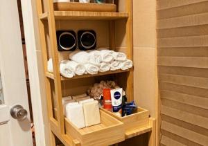 a cabinet with towels and toilet paper in a bathroom at The Old Corner House in Velingrad