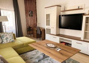 a living room with a couch and a tv at The Old Corner House in Velingrad +6 photos