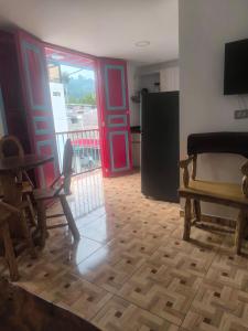a living room with red doors and a kitchen at apartamento vacacional red in Salento +14 photos