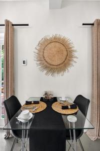 a dining room with a black table and chairs at Villa Costa Rose in Cape Town