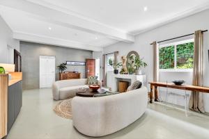a living room with a couch and a table at Villa Costa Rose in Cape Town