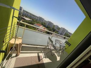 a balcony with tables and chairs on a building at Appartement Mona Lisa in Ris-Orangis