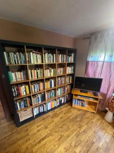 a living room with two book shelves filled with books at La Canàoula in Bobbio Pellice