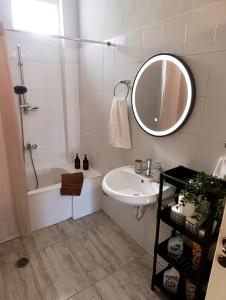 a white bathroom with a sink and a mirror at Canvista in Leptokarya +30 photos