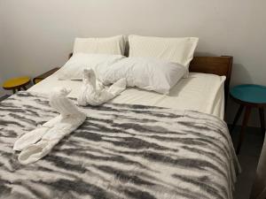 a bed with two stuffed animals laying on it at Kokoma Apartment in Katima Mulilo in Katima Mulilo +3 photos
