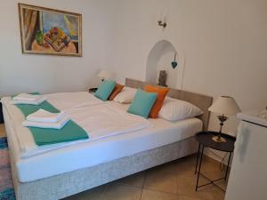a bed with towels on top of it in a room at Csopak Mariann Apartman in Csopak