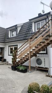 a house with a wooden deck in front of it at Berghaga in Köping