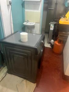 a small bathroom with a sink and a toilet at Chepchephm in Makindi