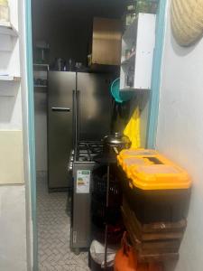 a kitchen with a stove and a refrigerator at Chepchephm in Makindi