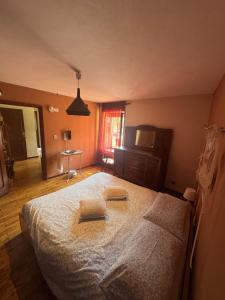 a bedroom with a bed with two towels on it at La Canàoula in Bobbio Pellice