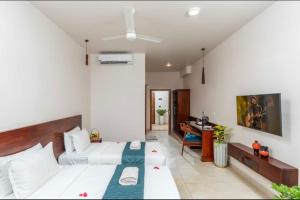 a bedroom with a bed and a desk in it at Citadel Boutique Hotel in Thekkady
