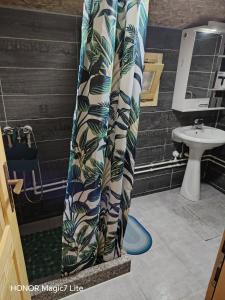 a shower curtain in a bathroom with a sink at Brvnare Dunja 1 i Dunja 2 in Kraljevo +52 photos