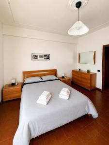 a bedroom with a large bed with two towels on it at Rome Home Cinecittà in Rome +11 photos