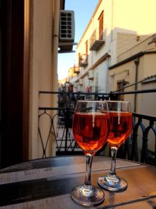 two glasses of wine sitting on top of a table at L'Approdo di Re Ruggero in Cefalù