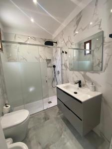 a bathroom with a toilet and a sink and a shower at L'Approdo di Re Ruggero in Cefalù +22 photos