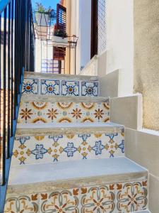 a set of stairs with blue and white tiles at L'Approdo di Re Ruggero in Cefalù