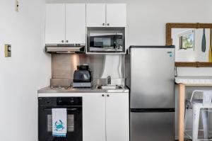 a kitchen with a refrigerator and a microwave at Assateague Inn 100-2R in Chincoteague