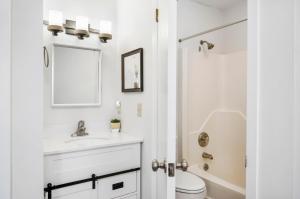 a white bathroom with a sink and a toilet at Assateague Inn 100-2R in Chincoteague +20 photos
