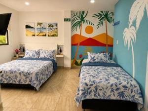 a bedroom with two beds and a mural on the wall at Avadia del Mar in Cartagena de Indias