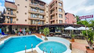 an outdoor swimming pool in front of a hotel at Friends Family Hotel in Sunny Beach +79 photos