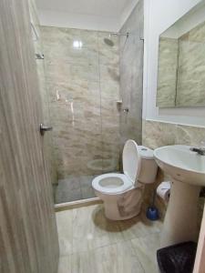 a bathroom with a toilet and a shower and a sink at Avadia del Mar in Cartagena de Indias