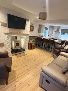 a living room with a fire place in a living room at Hughie Toms Cottage in Greencastle