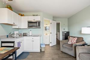 a kitchen and living room with a couch and a table at Assateague Inn 105-S in Deep Hole