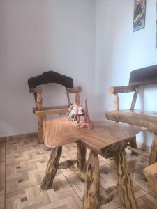 a wooden bench with a doll sitting on top of it at apartamento vacacional red 1 in Salento +20 photos