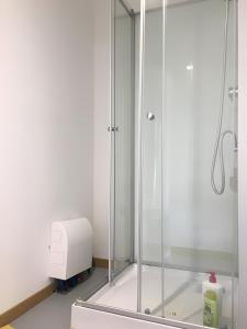 a glass shower in a bathroom with a toaster at Yourte Volcans Puy de Dome in Montfermy
