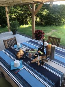 a blue table with food and candles on it at Yourte Volcans Puy de Dome in Montfermy