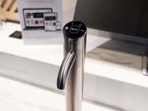 a metal pole with a computer monitor on a desk at Mercure Lorient Centre in Lorient