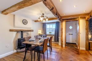 a dining room with a table and chairs and a wood stove at 2 Bed in Penrith oc-87349 in Penrith