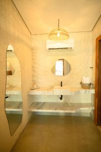 a bathroom with a sink and a mirror at Desfrute Pousada e Experiencia in Arraial d'Ajuda +22 photos