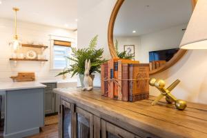 a pile of books on a table with a mirror at Kildahl House - Boutique Farmhouse Suite #1 in West Dundee +12 photos