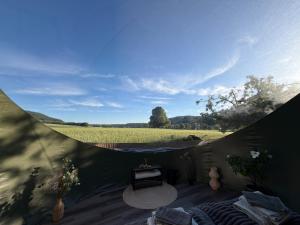 a tent with a table and a view of a field at Bubble Tent Altmühltal in Greding