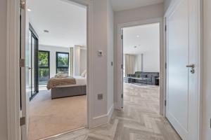 a bedroom with a bed and a door leading to a living room at Spacious North London Flat Sleeps 4 in New Barnet