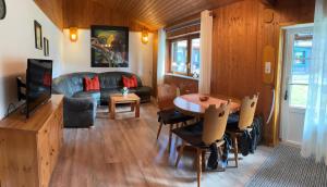 a living room with a table and a couch at Familija in Straupitz