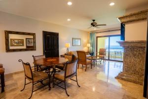 a living room with a fireplace and a table and chairs at Las Villas Hotel & Golf By Estrella del Mar in Mazatlán