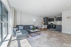 a living room with a couch and a table at Spacious North London Flat Sleeps 4 in New Barnet