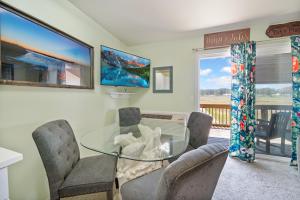 a dining room with a glass table and chairs at Assateague Inn 206-S in Chincoteague