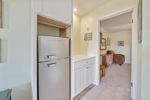 a kitchen with a white refrigerator in a room at Assateague Inn 206-S in Chincoteague +13 photos
