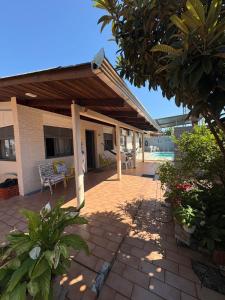 a patio with awning on top of a building at Suíte aconchego dos pássaros in Guaratuba