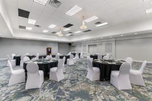 a conference room with tables and white chairs at Best Western Dorchester Hotel in Nanaimo