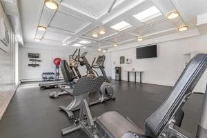 a gym with rows of treadmills and machines at Best Western Dorchester Hotel in Nanaimo