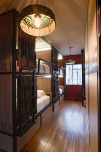 a room with two bunk beds and a chandelier at Bendito Hostels in Bogotá