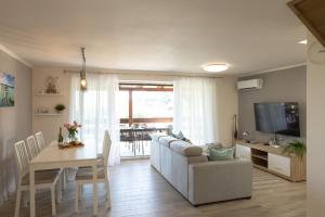 a living room with a couch and a table at Kardos Villa in Szigliget