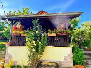 a house with flowers on a wooden balcony at Cozy Quiet Retreat 70km from Sofia in Kyustendil