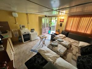 a living room with a bed and a stove in it at Cozy Quiet Retreat 70km from Sofia in Kyustendil