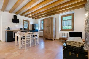 a kitchen and dining room with a table and chairs at Casa Zucchelli in Tenno